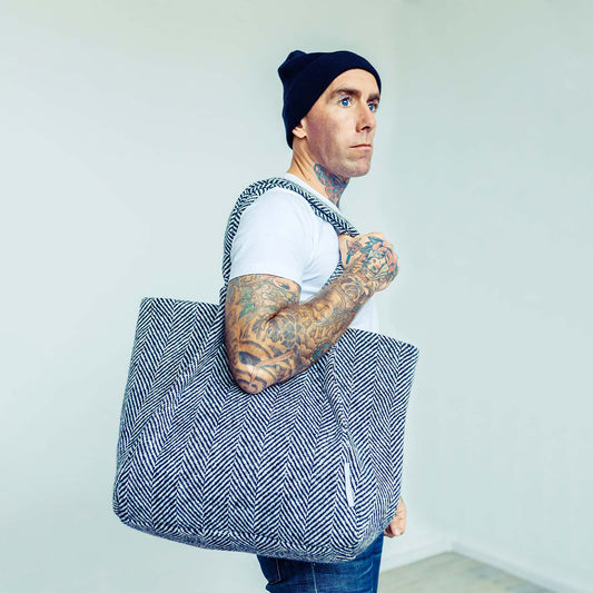 Man wearing The Costume Room monochrome herringbone Handwoven Donegal Tweed Bag on his shoulder
