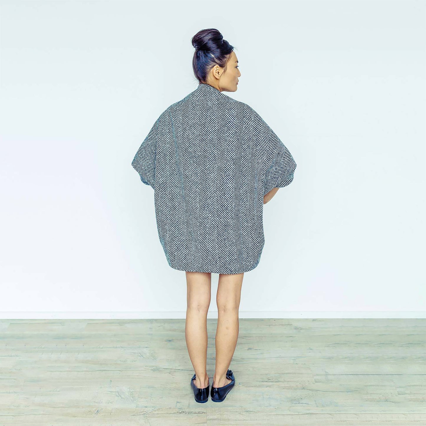 Woman wearing The Costume Room monochrome herringbone Handwoven Donegal Tweed Cocoon Dress