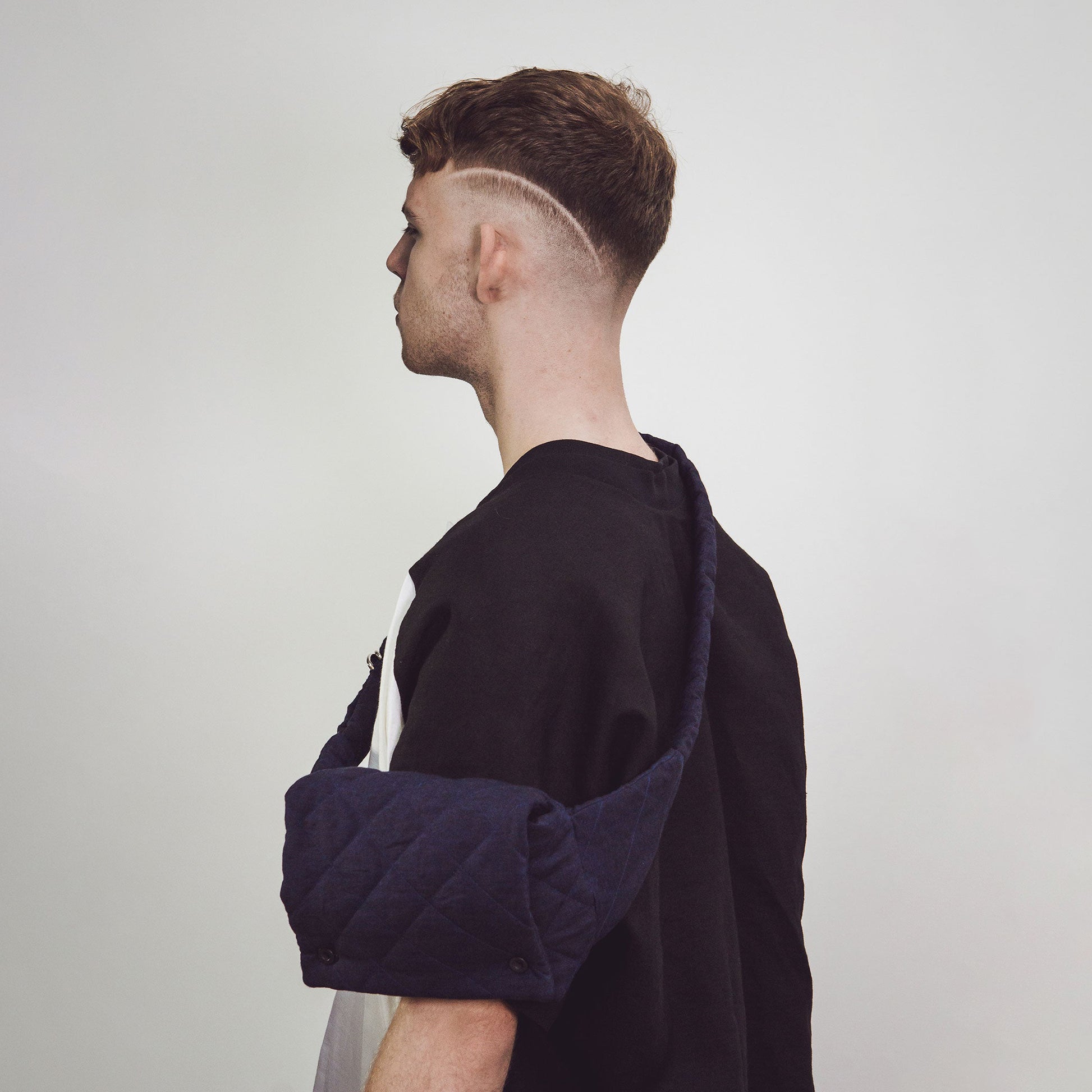 Man wearing The Costume Room Navy Blue Linen Quilted Belt Bag