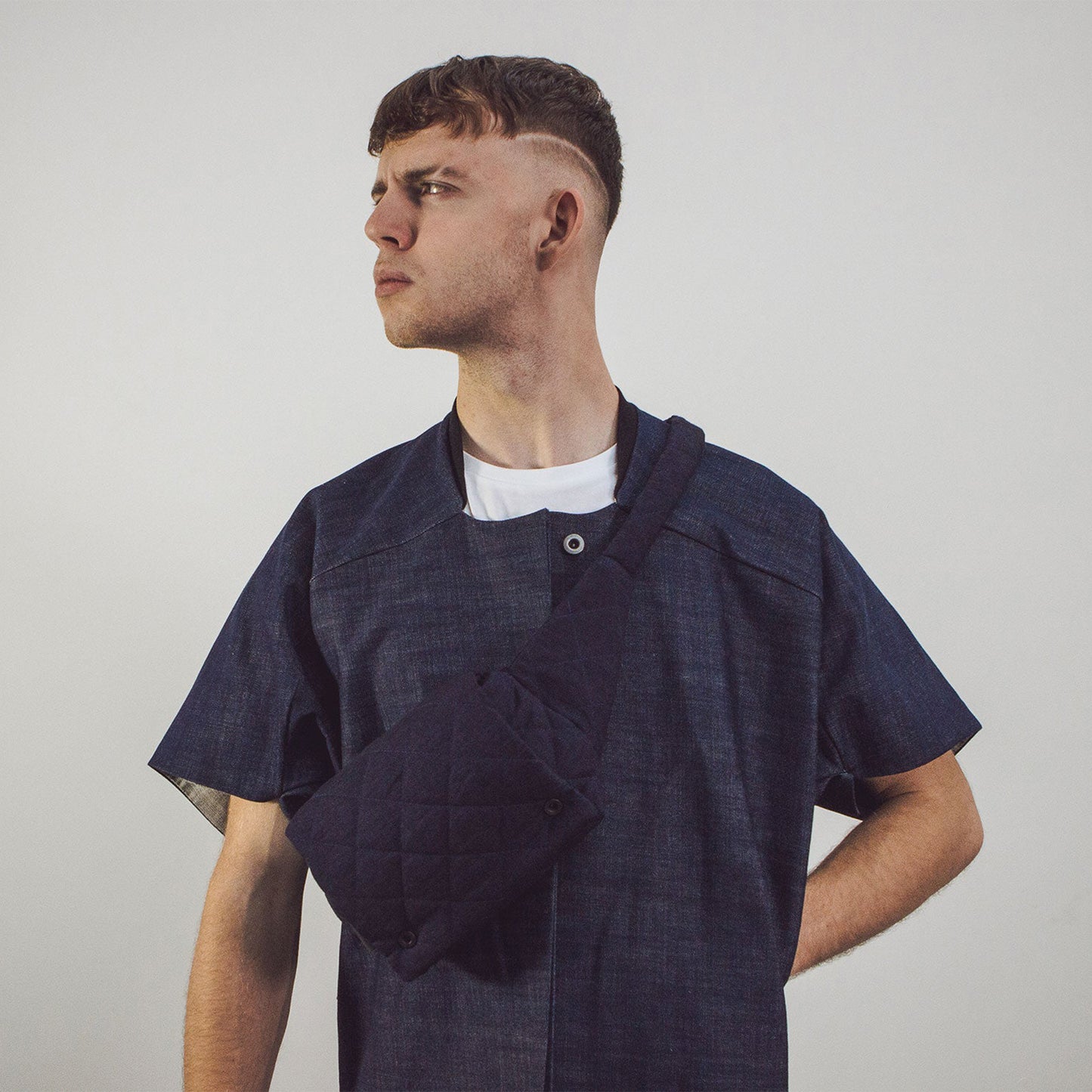 Man wearing The Costume Room Navy Blue Linen Quilted Belt Bag