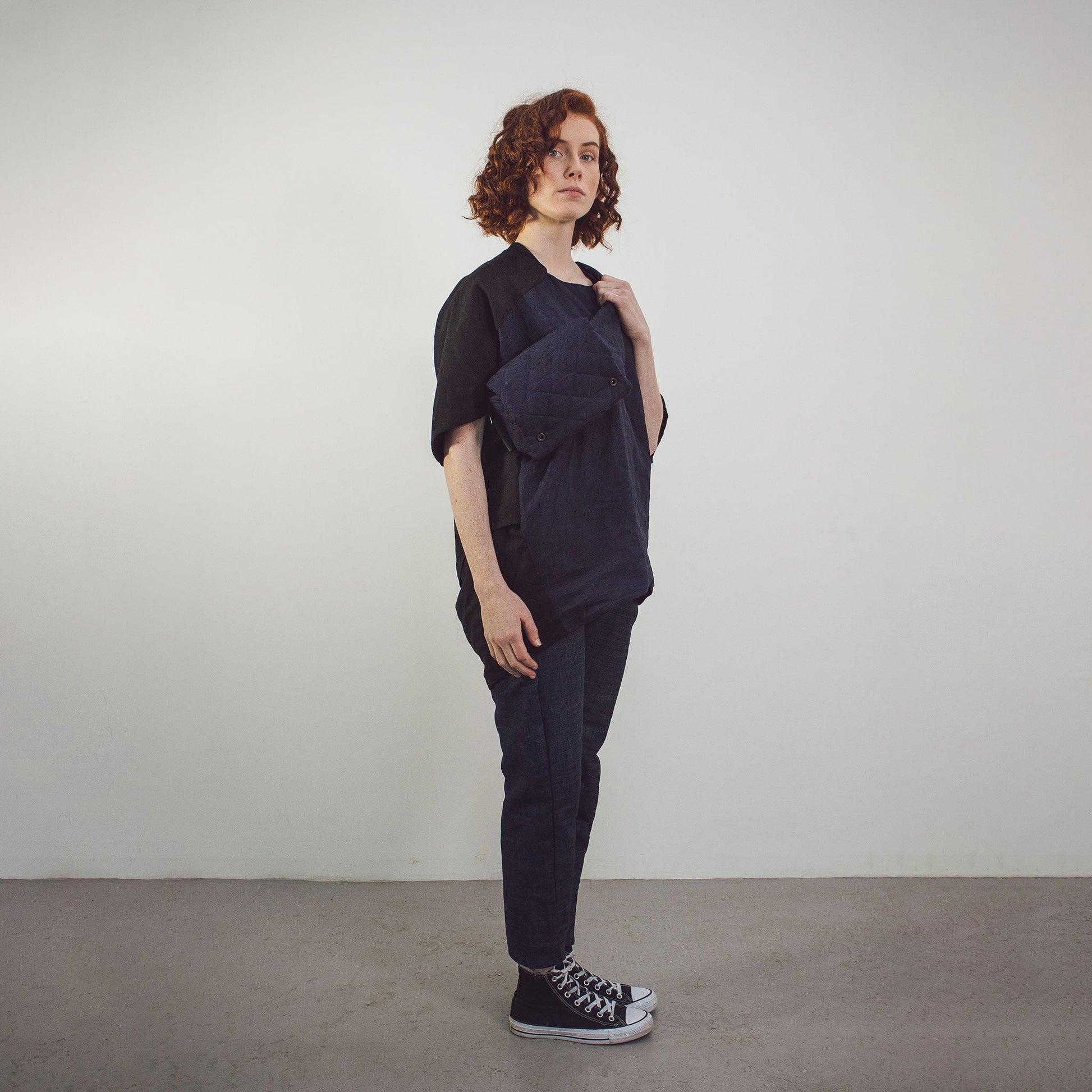 Woman with red hair wearing The Costume Room Navy Blue Linen Quilted Belt Bag