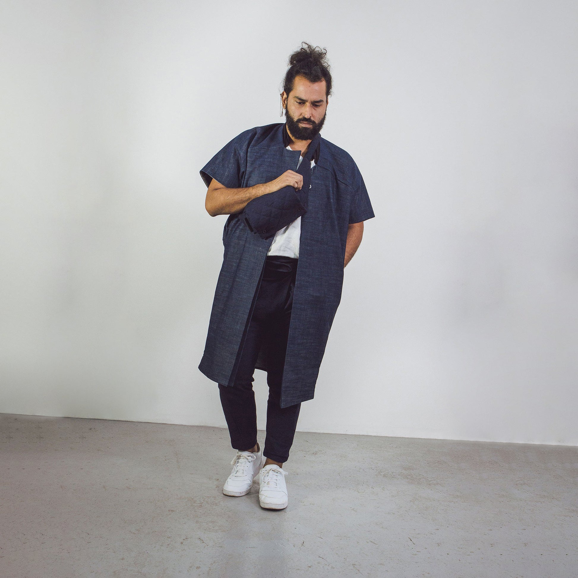 Man wearing The Costume Room Navy Blue Linen Quilted Belt Bag