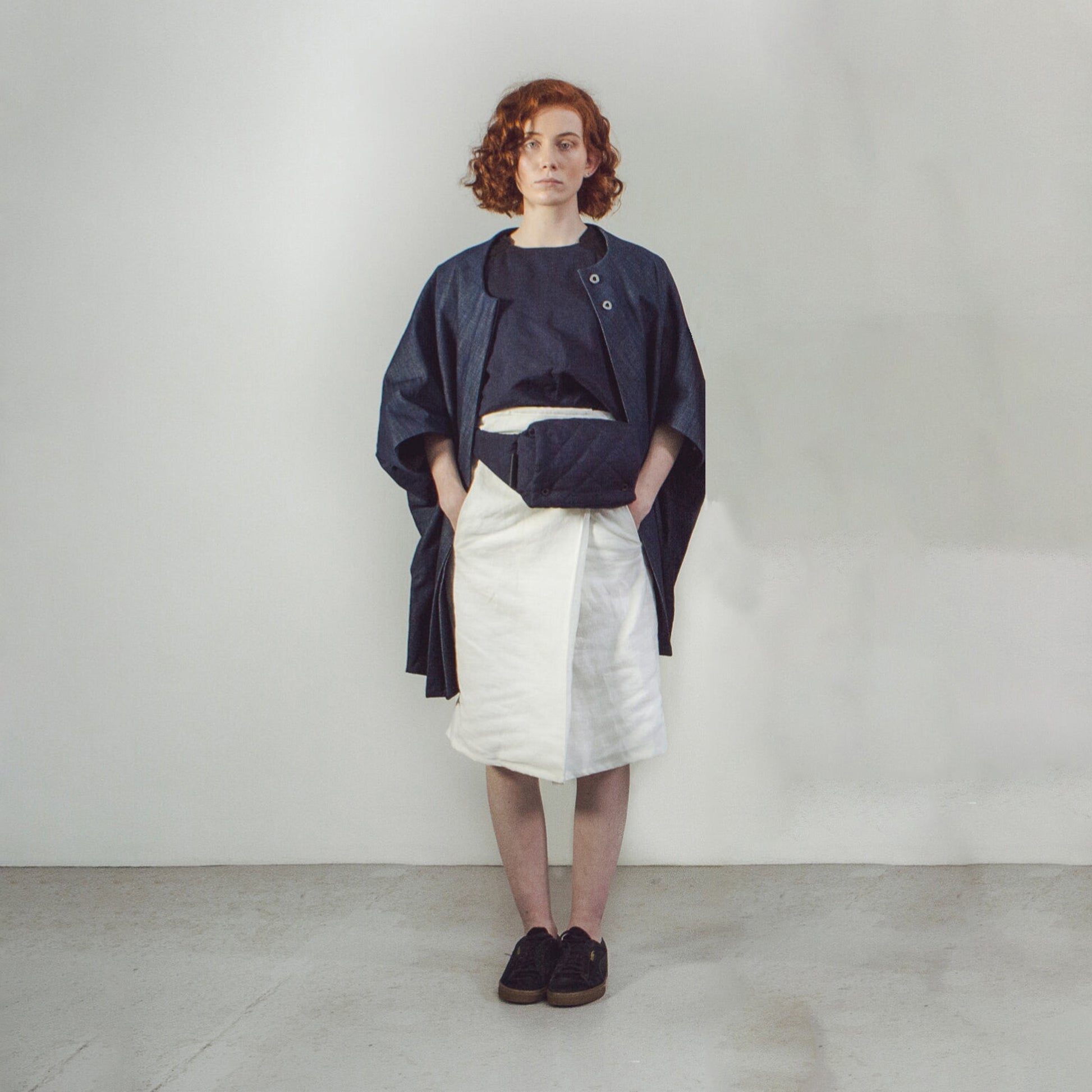 Woman with red hair wearing The Costume Room Navy Blue Linen Quilted Belt Bag