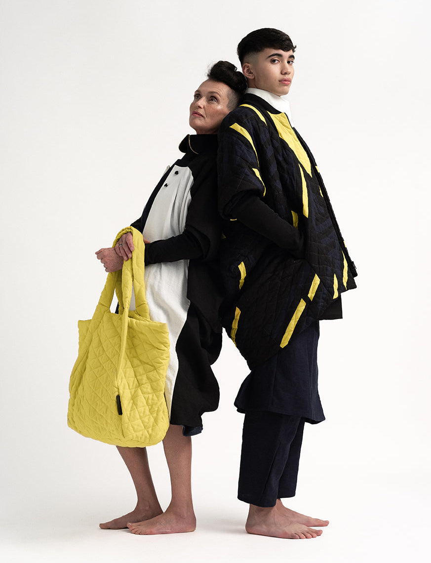 Two models wearing sculptural gender-neutral pieces in 100% pure Irish linen by The Costume Room.