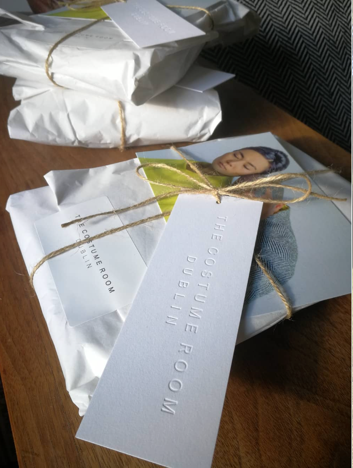 Wrapped The Costume Room pieces in paper packaging with embossed studio tags and natural twine.