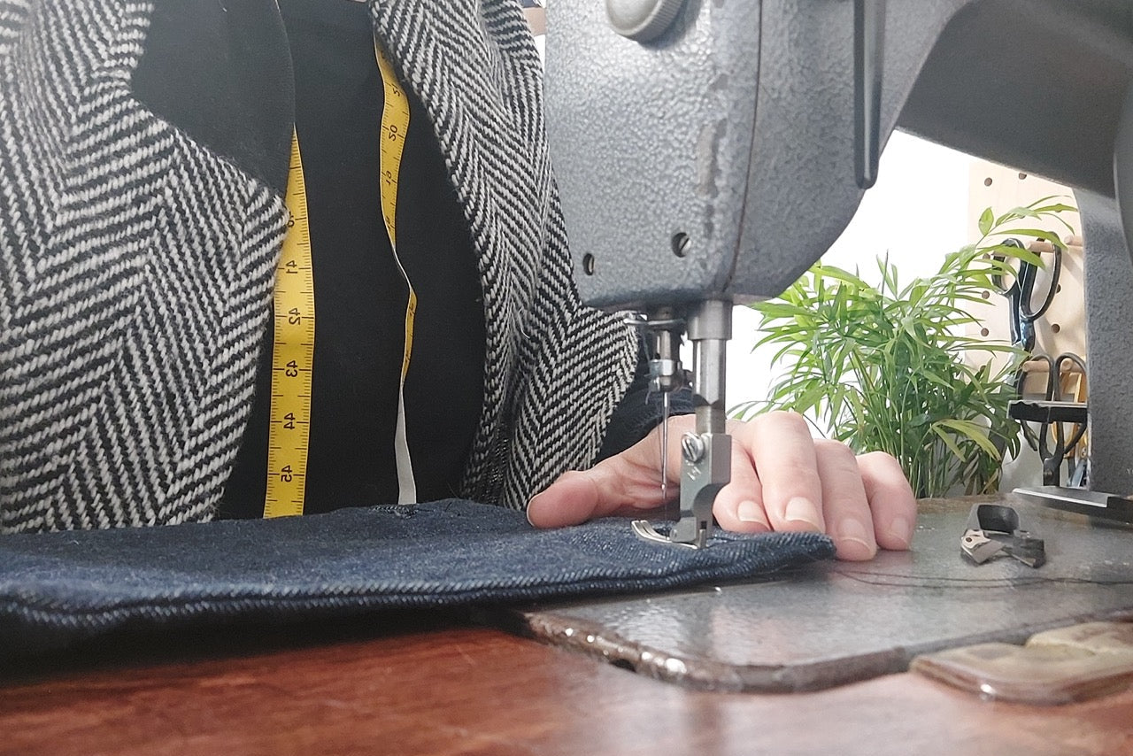 Raw organic indigo denim being sewn within The Costume Room studio.