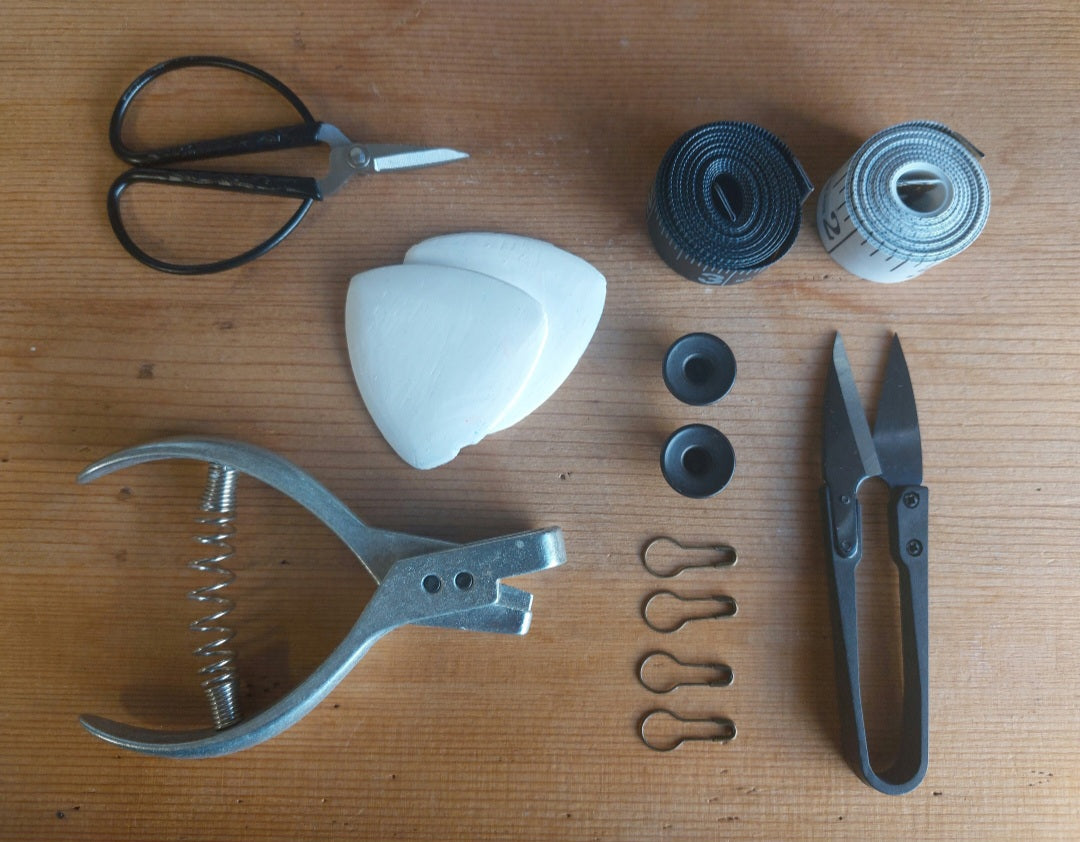 Studio tools and materials arranged on a wooden table at The Costume Room studio in Dublin, Ireland.