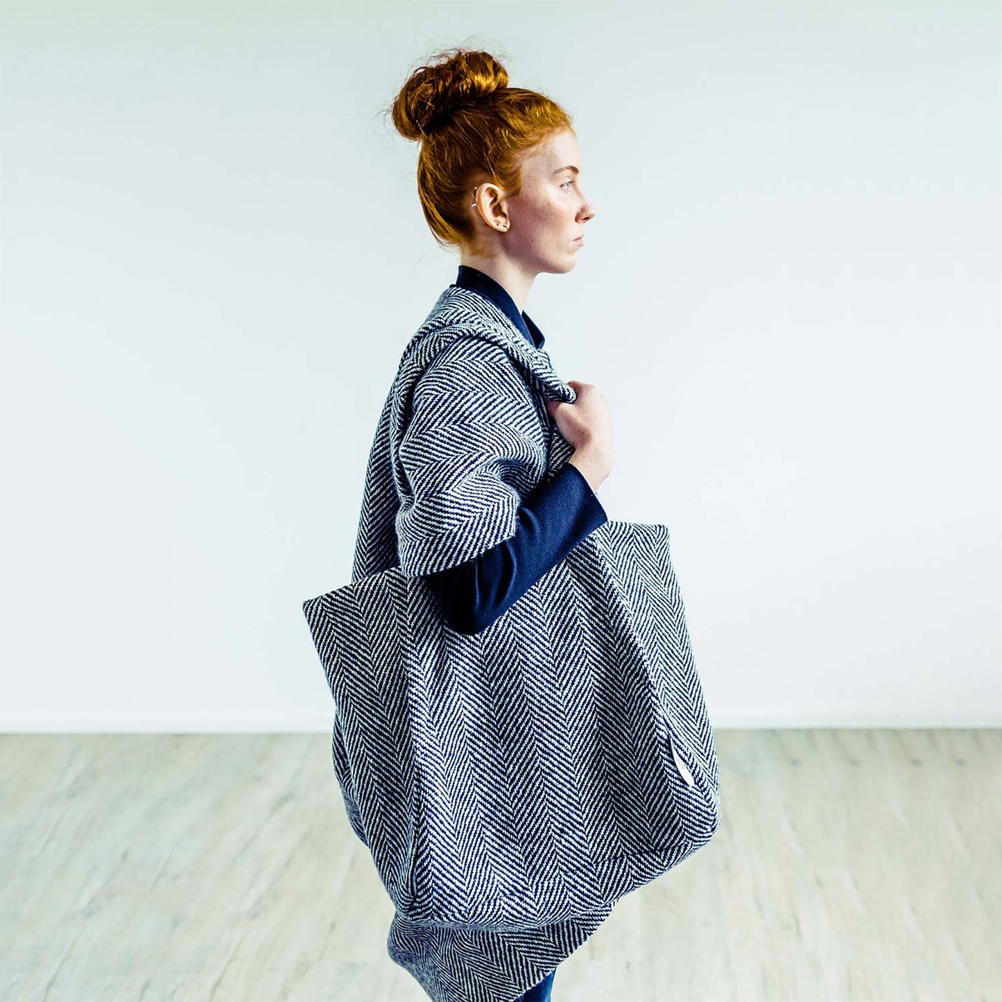 Woman in Dublin wearing The Costume Room monochrome herringbone Handwoven Donegal Tweed Bag