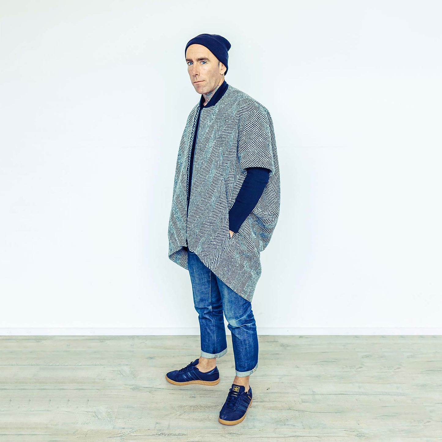 Man wearing The Costume Room monochrome herringbone Handwoven Donegal Tweed Cocoon Coat