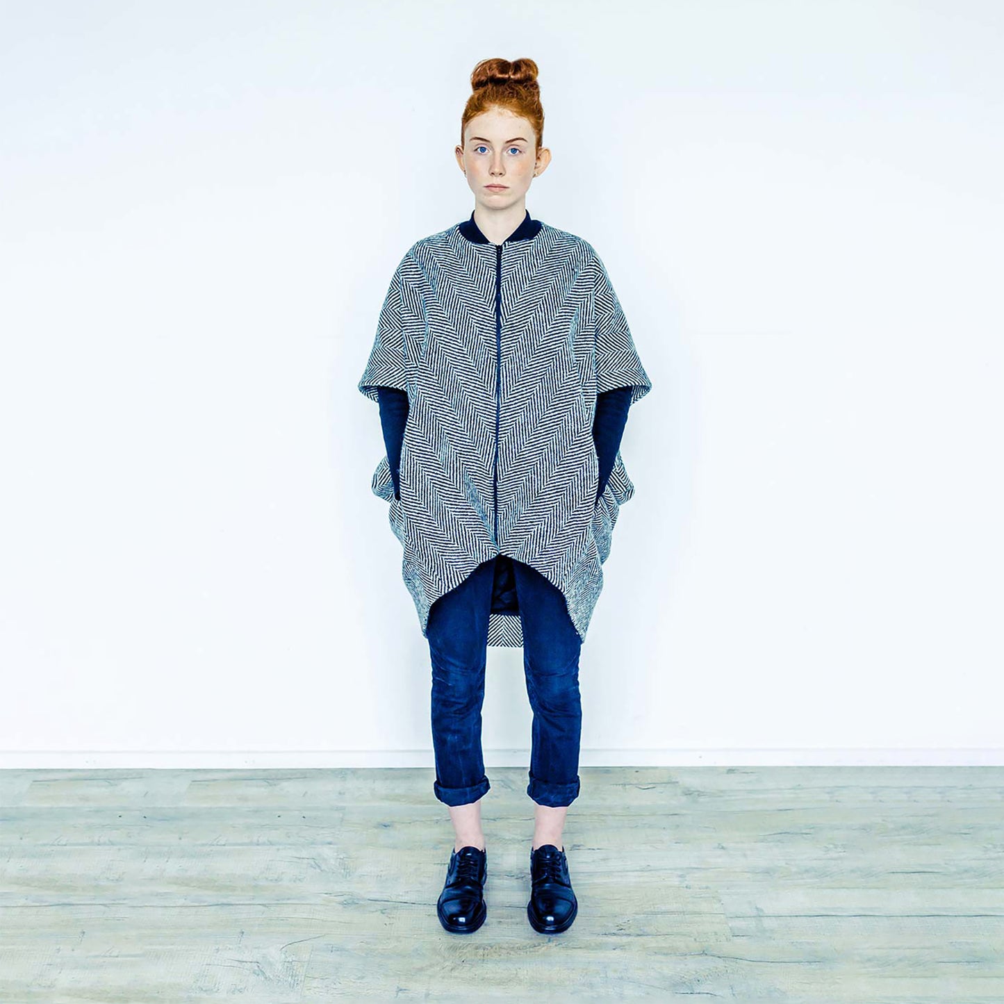 Red hair woman wearing The Costume Room monochrome herringbone Handwoven Donegal Tweed Cocoon Coat