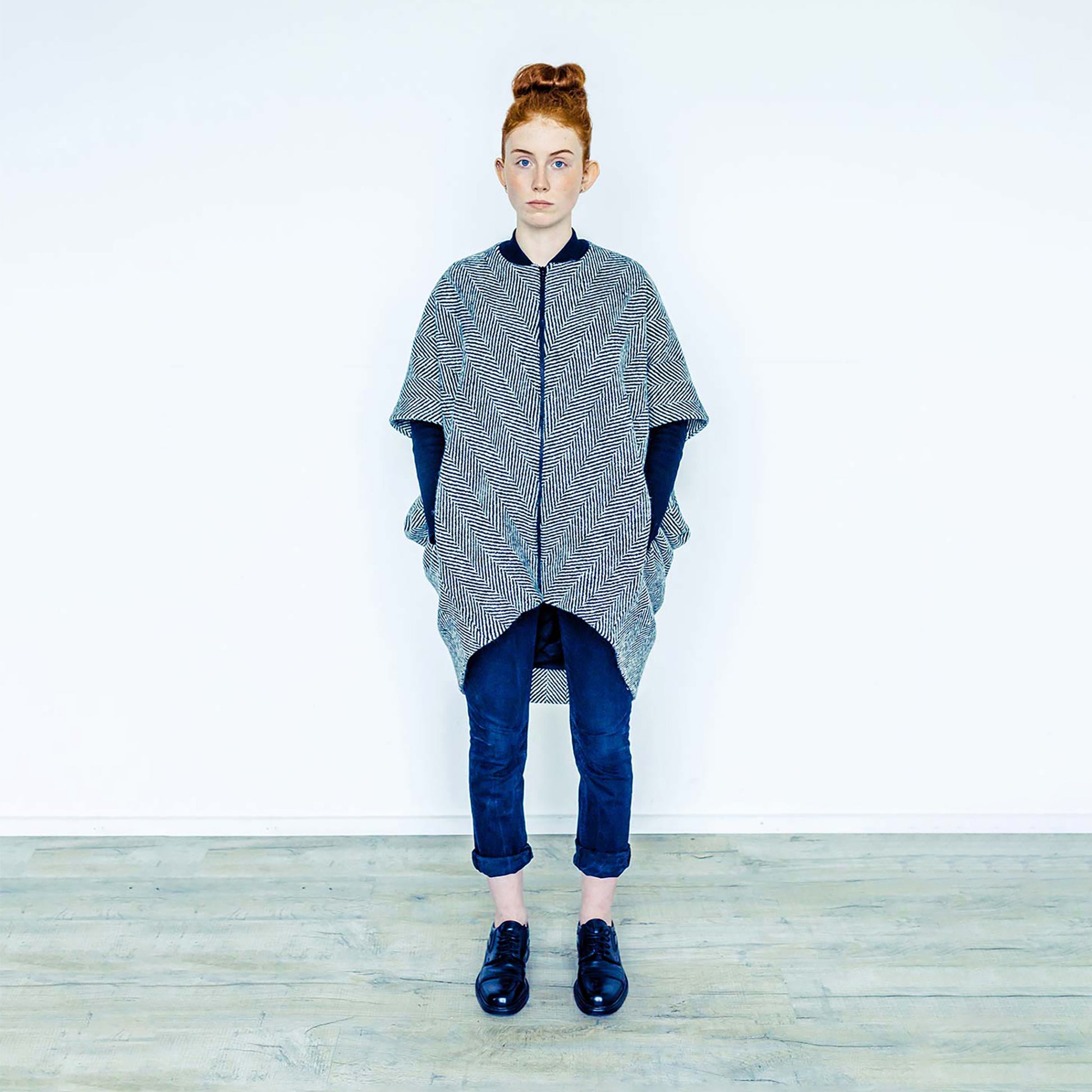Red hair woman wearing The Costume Room monochrome herringbone Handwoven Donegal Tweed Cocoon Coat