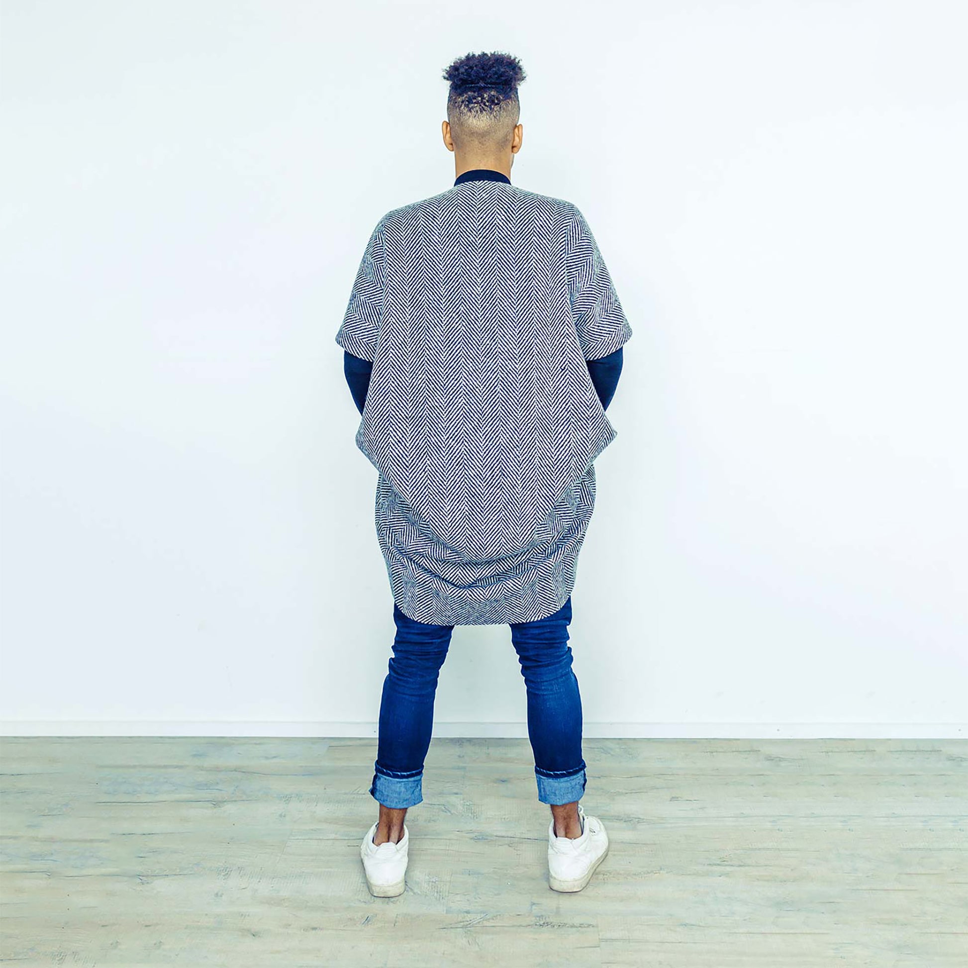 Man wearing The Costume Room monochrome herringbone Handwoven Donegal Tweed Cocoon Coat