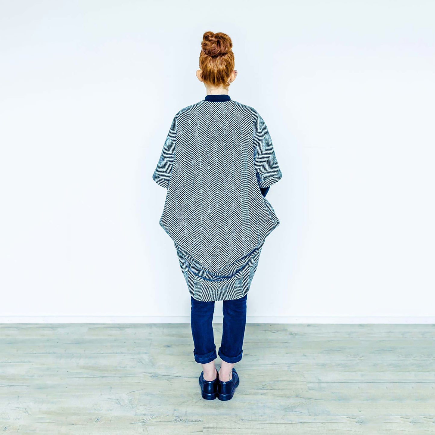 Red hair woman wearing The Costume Room monochrome herringbone Handwoven Donegal Tweed Cocoon Coat