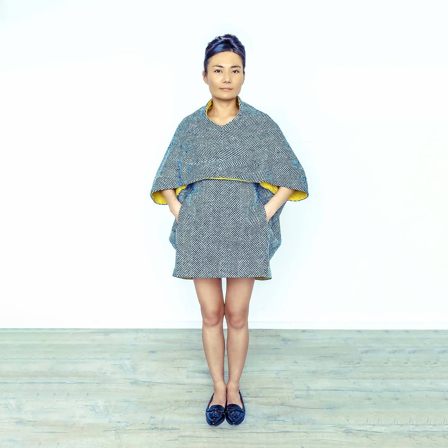 Woman wearing The Costume Room monochrome herringbone Handwoven Donegal Tweed Cocoon Dress