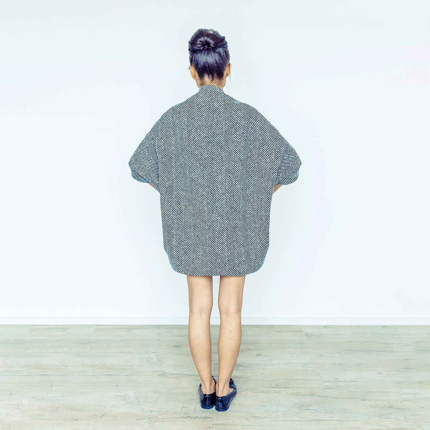 Woman wearing The Costume Room monochrome herringbone Handwoven Donegal Tweed Cocoon Dress