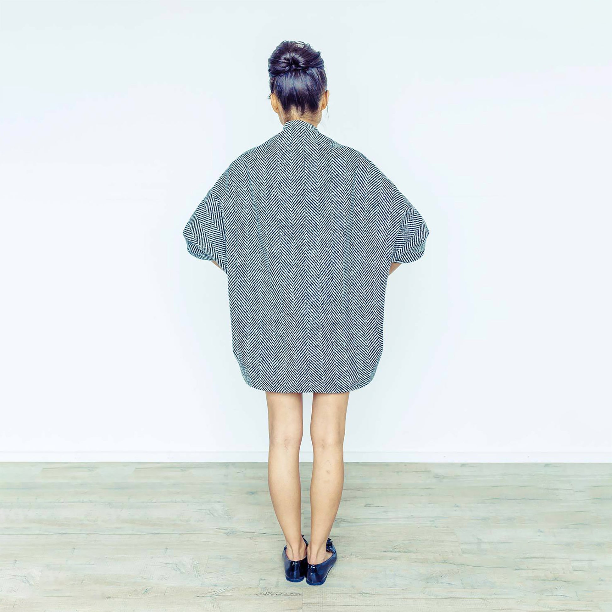 Woman wearing The Costume Room monochrome herringbone Handwoven Donegal Tweed Cocoon Dress