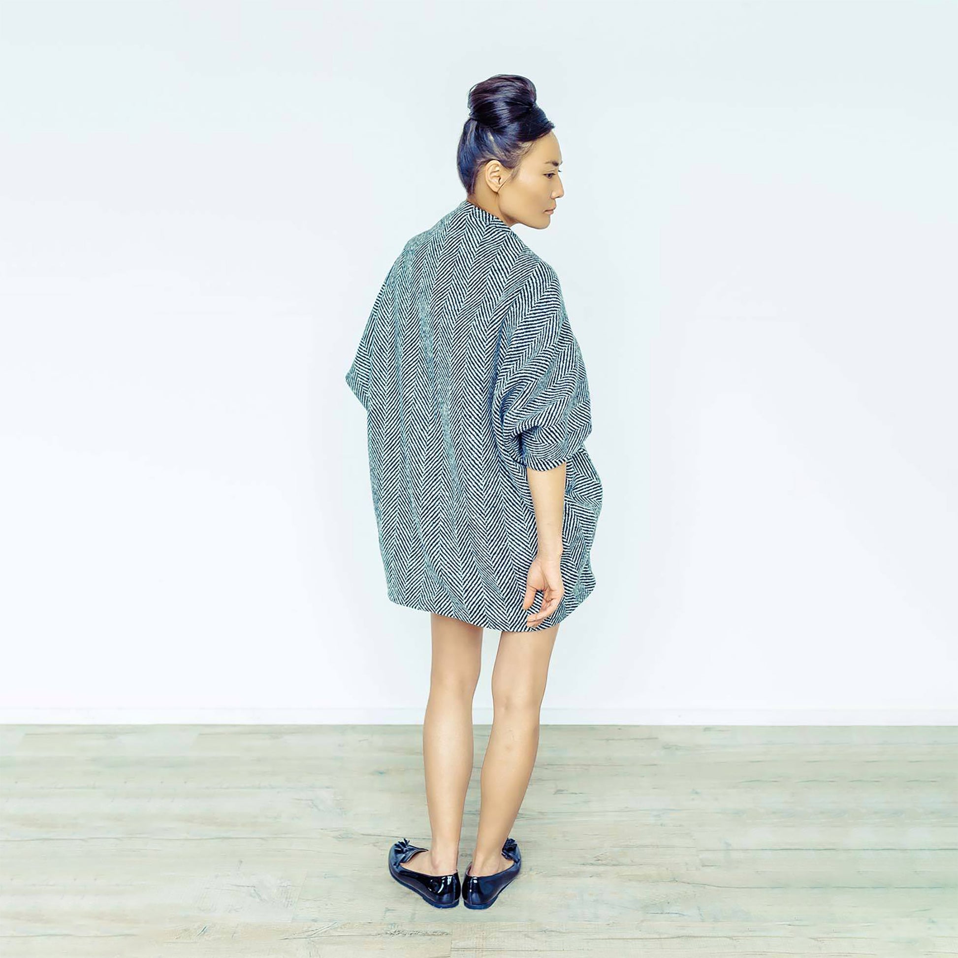 Woman wearing The Costume Room monochrome herringbone Handwoven Donegal Tweed Cocoon Dress