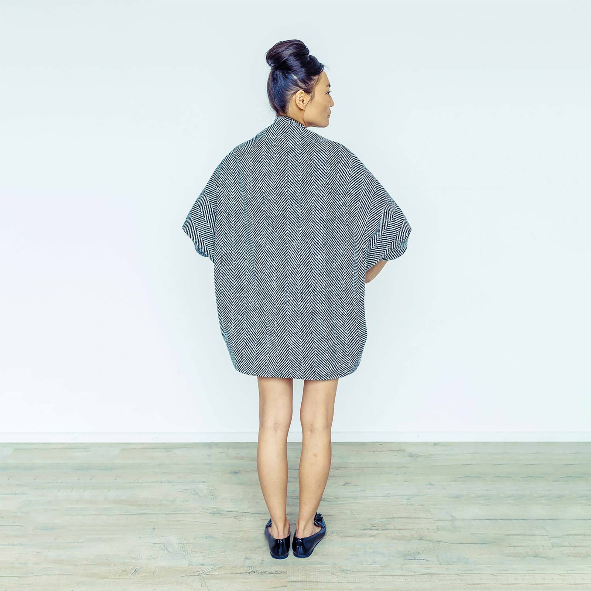 Woman wearing The Costume Room monochrome herringbone Handwoven Donegal Tweed Cocoon Dress