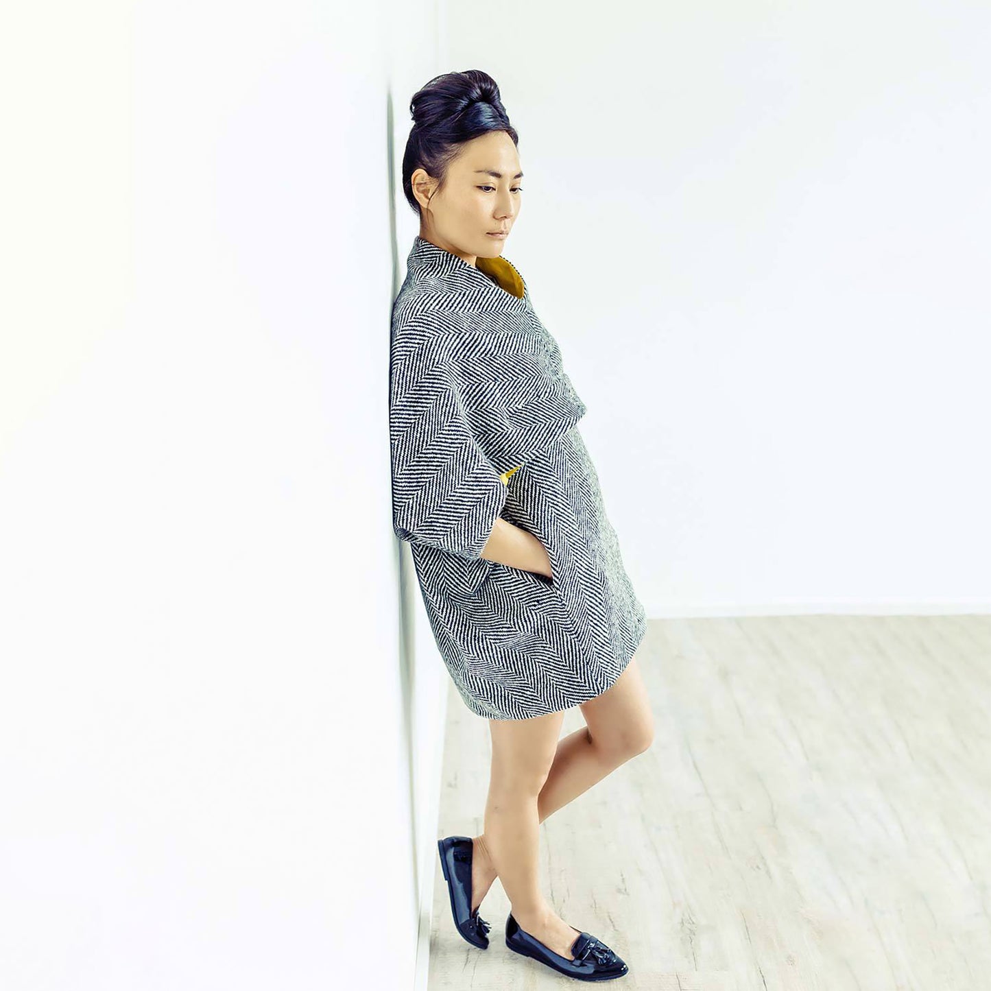 Woman wearing The Costume Room monochrome herringbone Handwoven Donegal Tweed Cocoon Dress