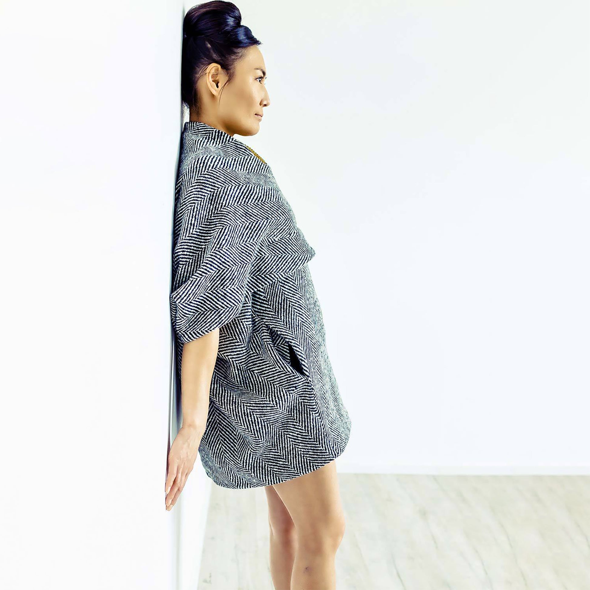 Woman wearing The Costume Room monochrome herringbone Handwoven Donegal Tweed Cocoon Dress