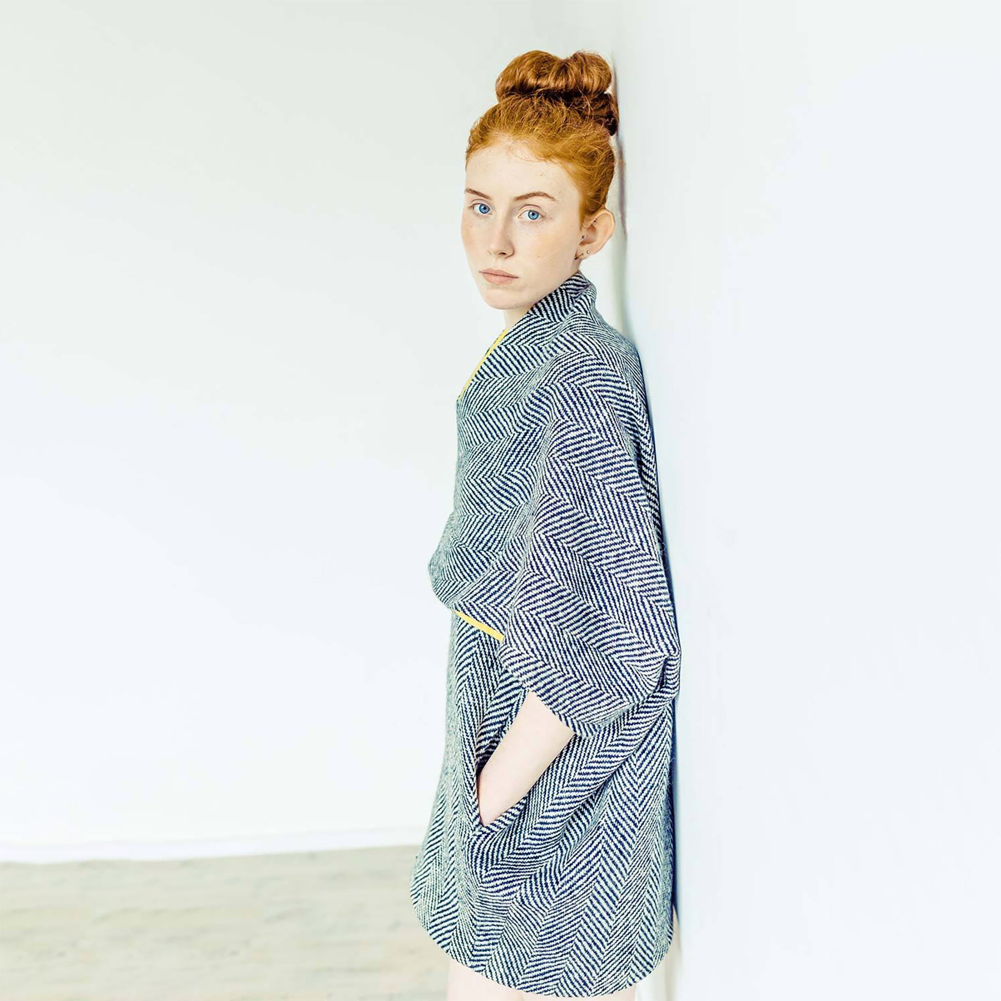 Woman wearing The Costume Room monochrome herringbone Handwoven Donegal Tweed Cocoon Dress