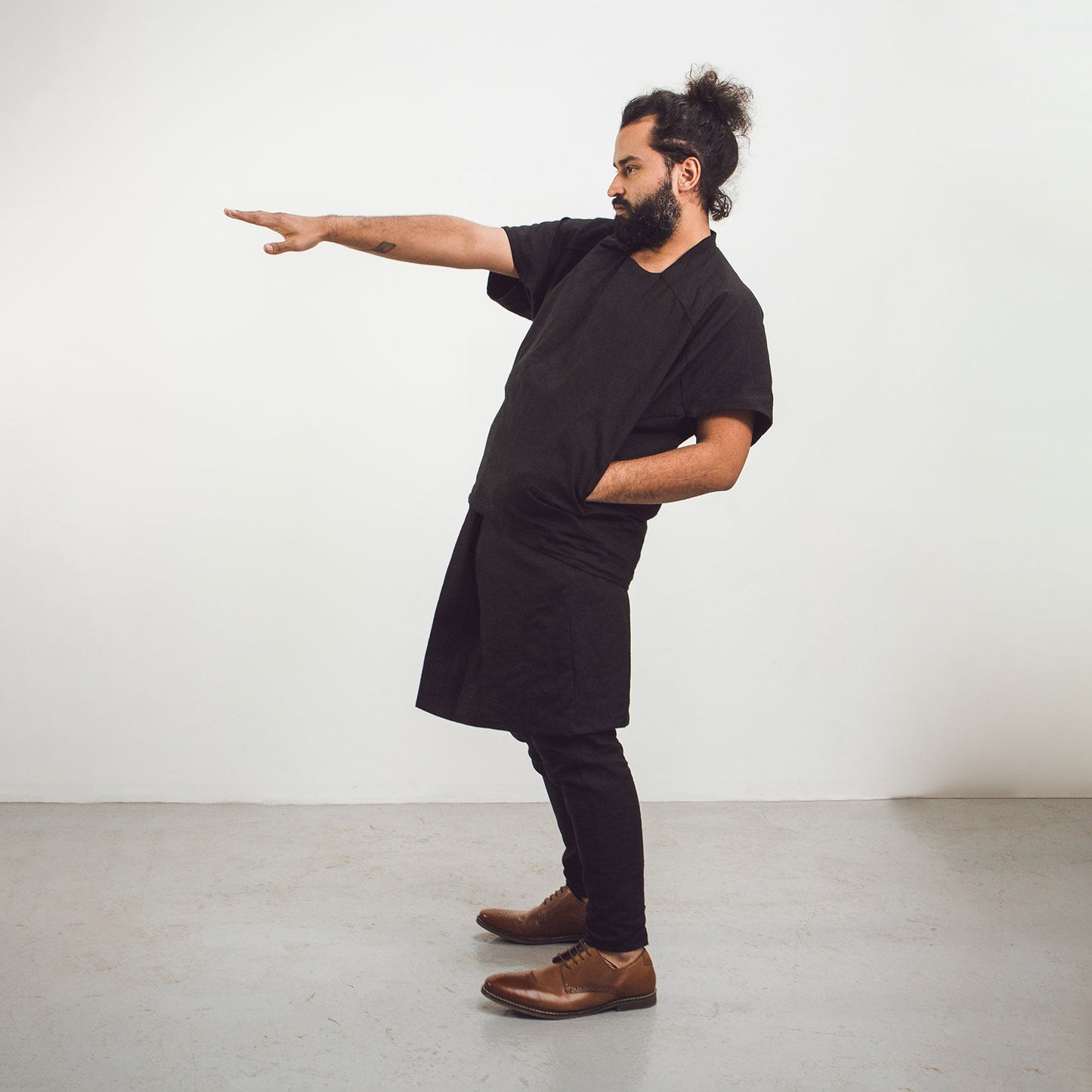 Man wearing The Costume Room Black 100% Pure Irish Linen Asymmetric Skirt