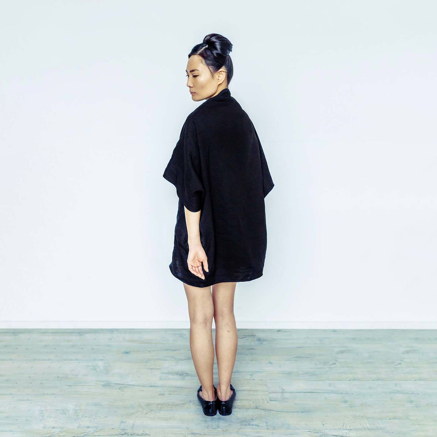 Woman wearing The Costume Room black 100% Pure Irish Linen Cocoon dress with pockets