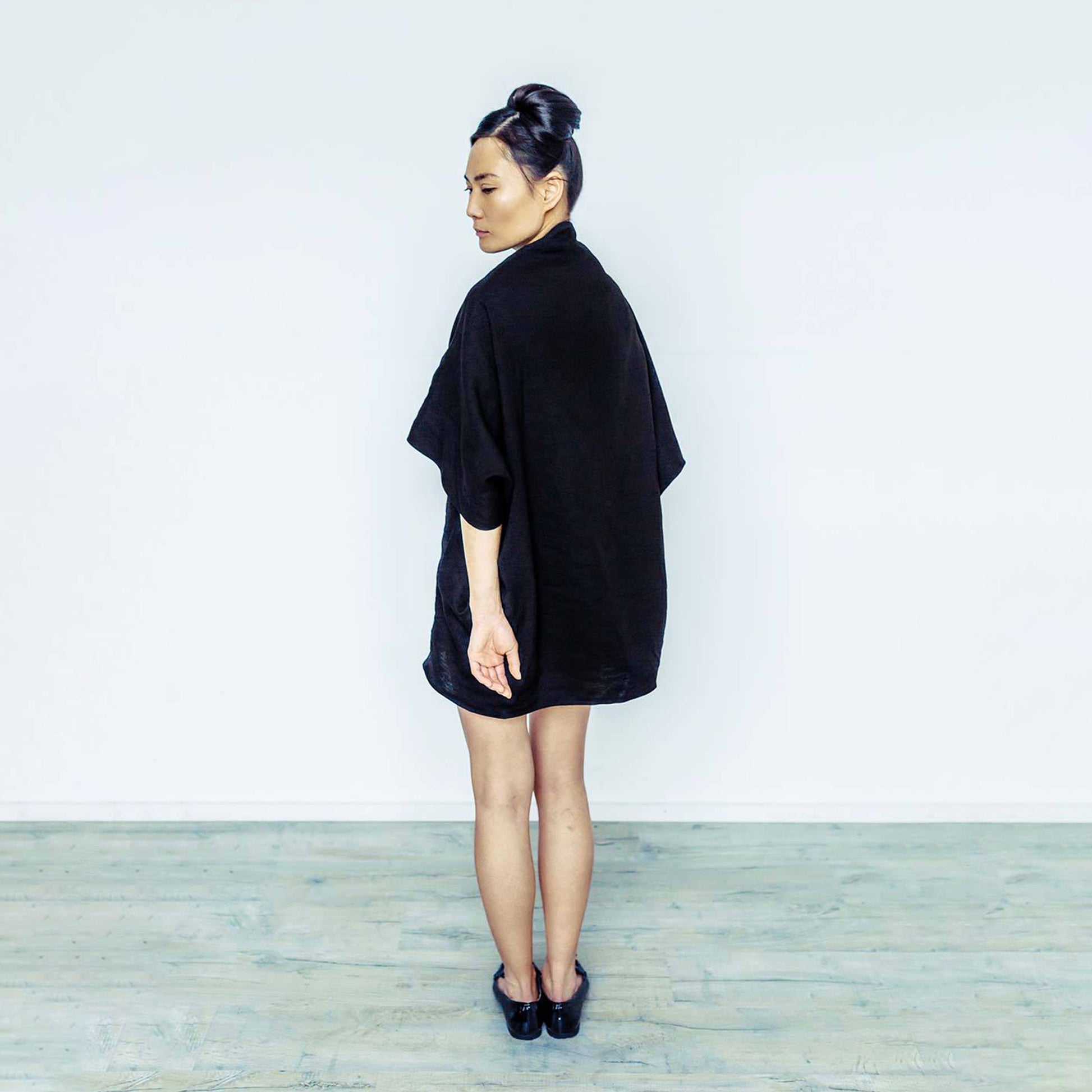 Woman wearing The Costume Room black 100% Pure Irish Linen Cocoon dress with pockets