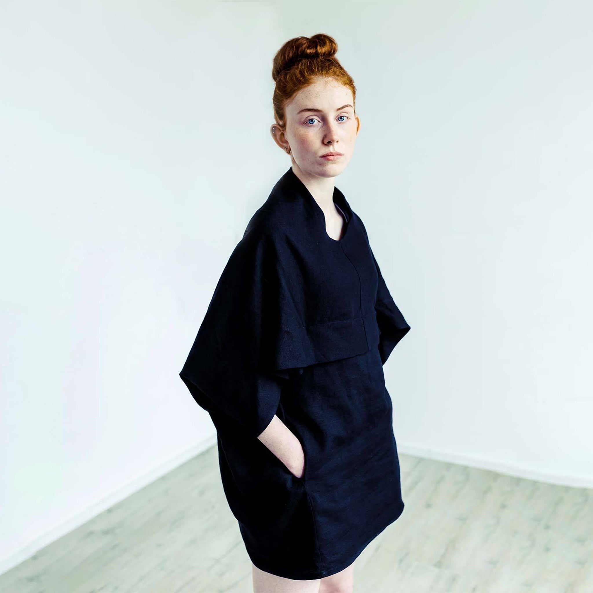 Red hair woman wearing The Costume Room black 100% Pure Irish Linen Cocoon dress with pockets