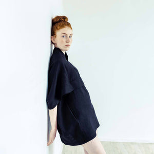 Red hair woman wearing The Costume Room black 100% Pure Irish Linen Cocoon dress with pockets