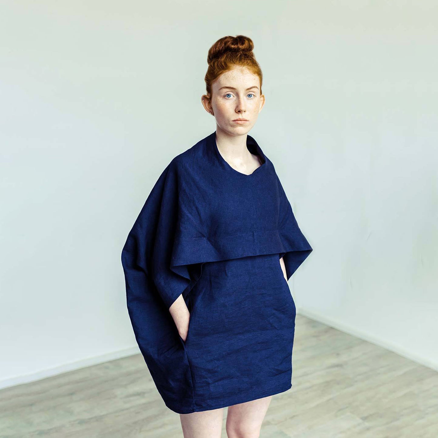 Red hair woman wearing The Costume Room navy blue 100% Pure Irish Linen Cocoon dress with pockets