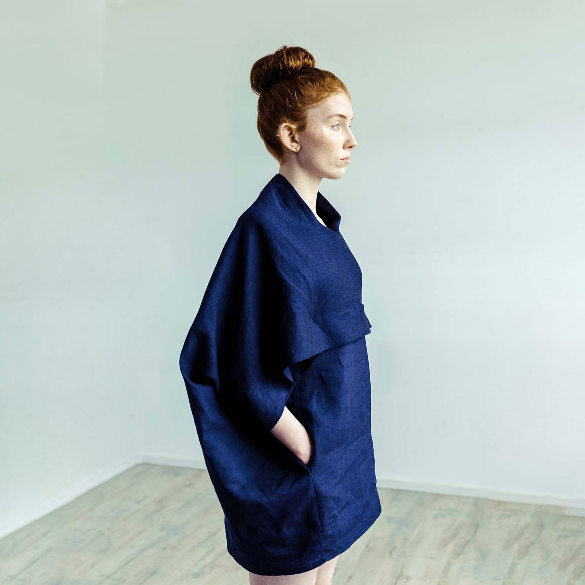 Red hair woman wearing The Costume Room navy blue 100% Pure Irish Linen Cocoon dress with pockets