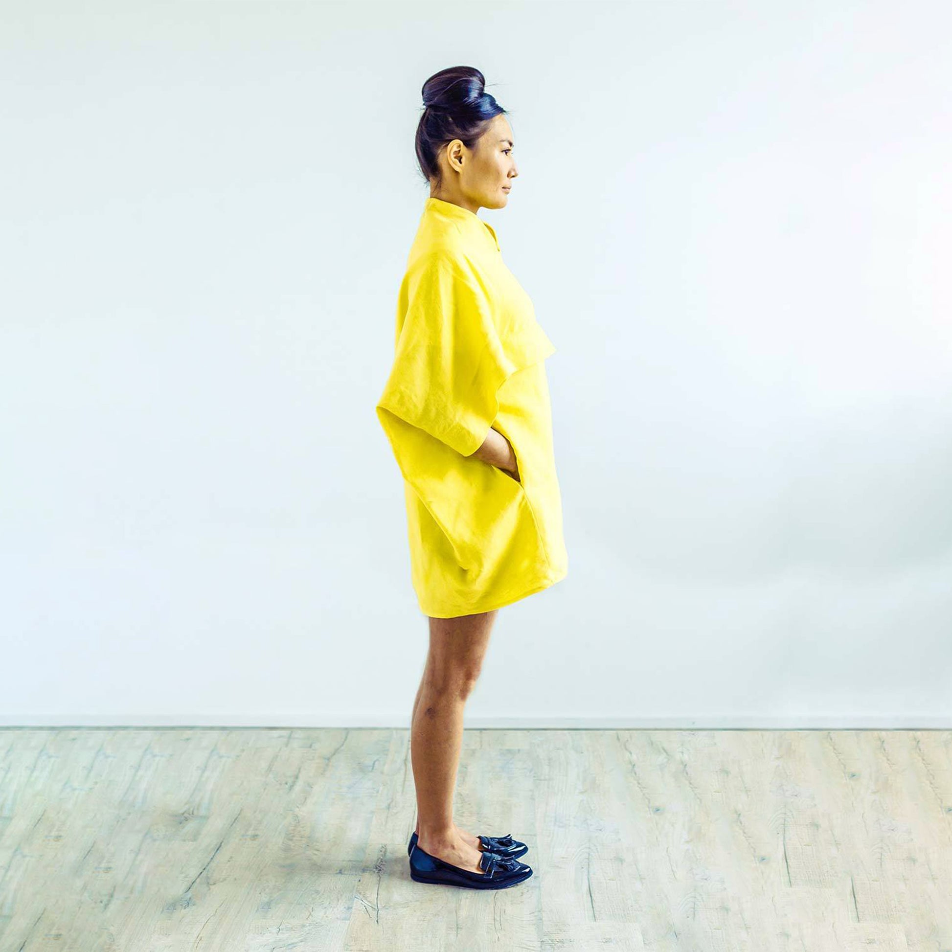 Woman wearing The Costume Room sunshine yellow 100% Pure Irish Linen Cocoon dress with pockets