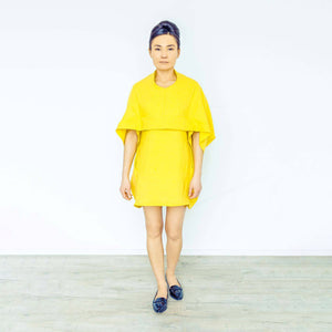 Woman wearing The Costume Room sunshine yellow 100% Pure Irish Linen Cocoon dress with pockets
