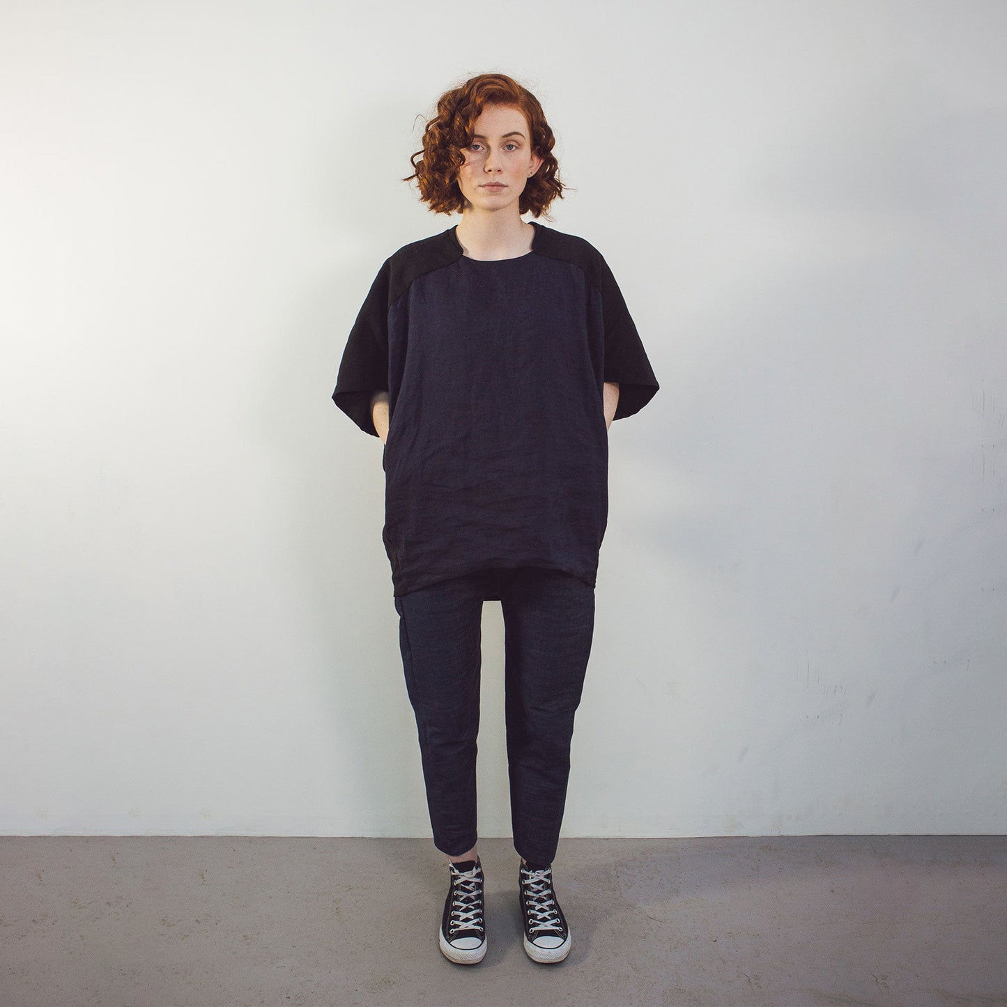 Woman wearing The Costume Room black and navy blue Linen Cocoon Top with pockets-gender-neutral