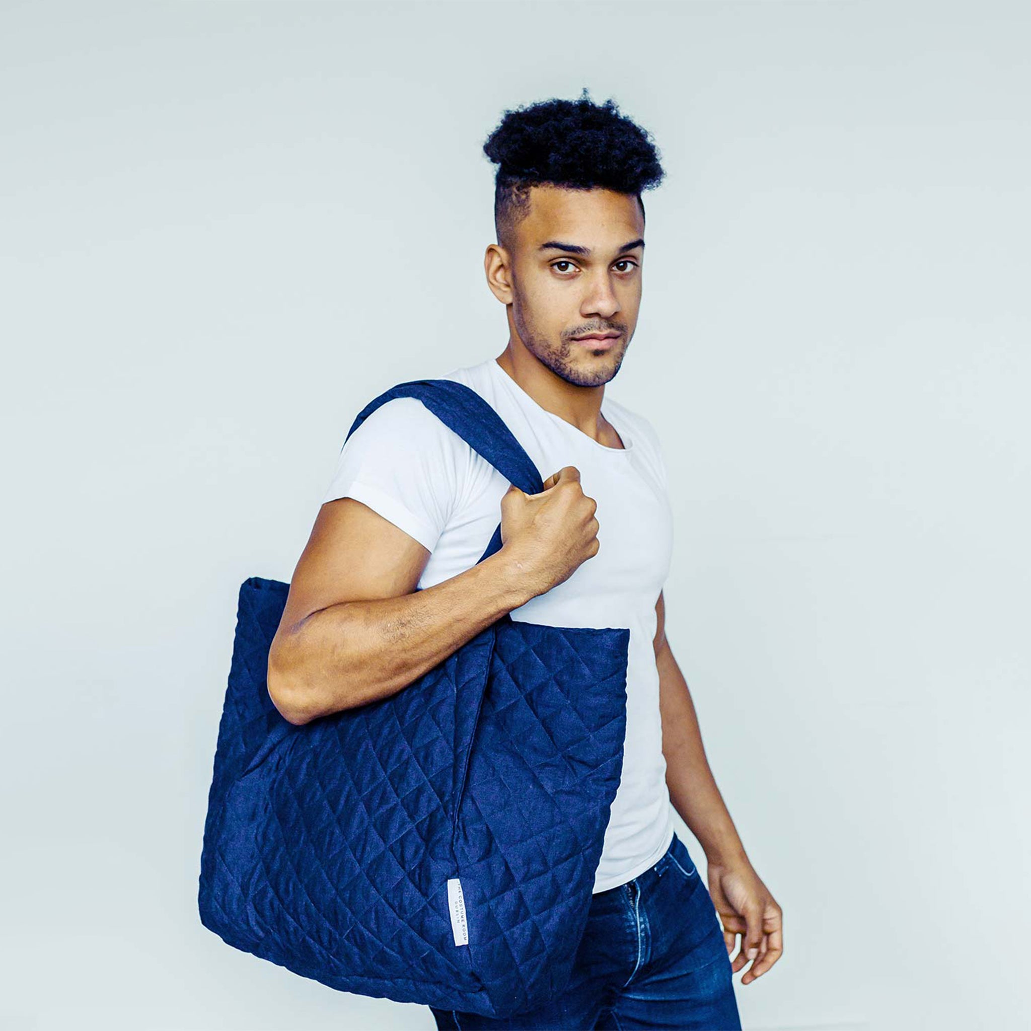 Man wearing The Costume Room navy blue 100% Pure Irish Linen Quilted Bag over his shoulder