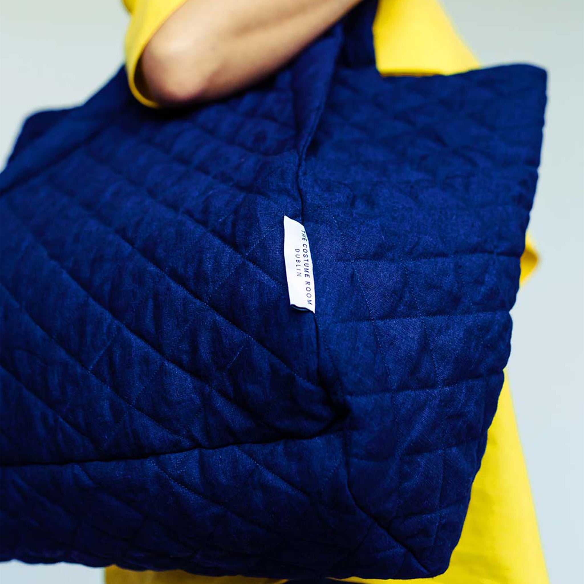 Woman wearing The Costume Room navy blue 100% Pure Irish Linen Quilted Bag on her shoulder