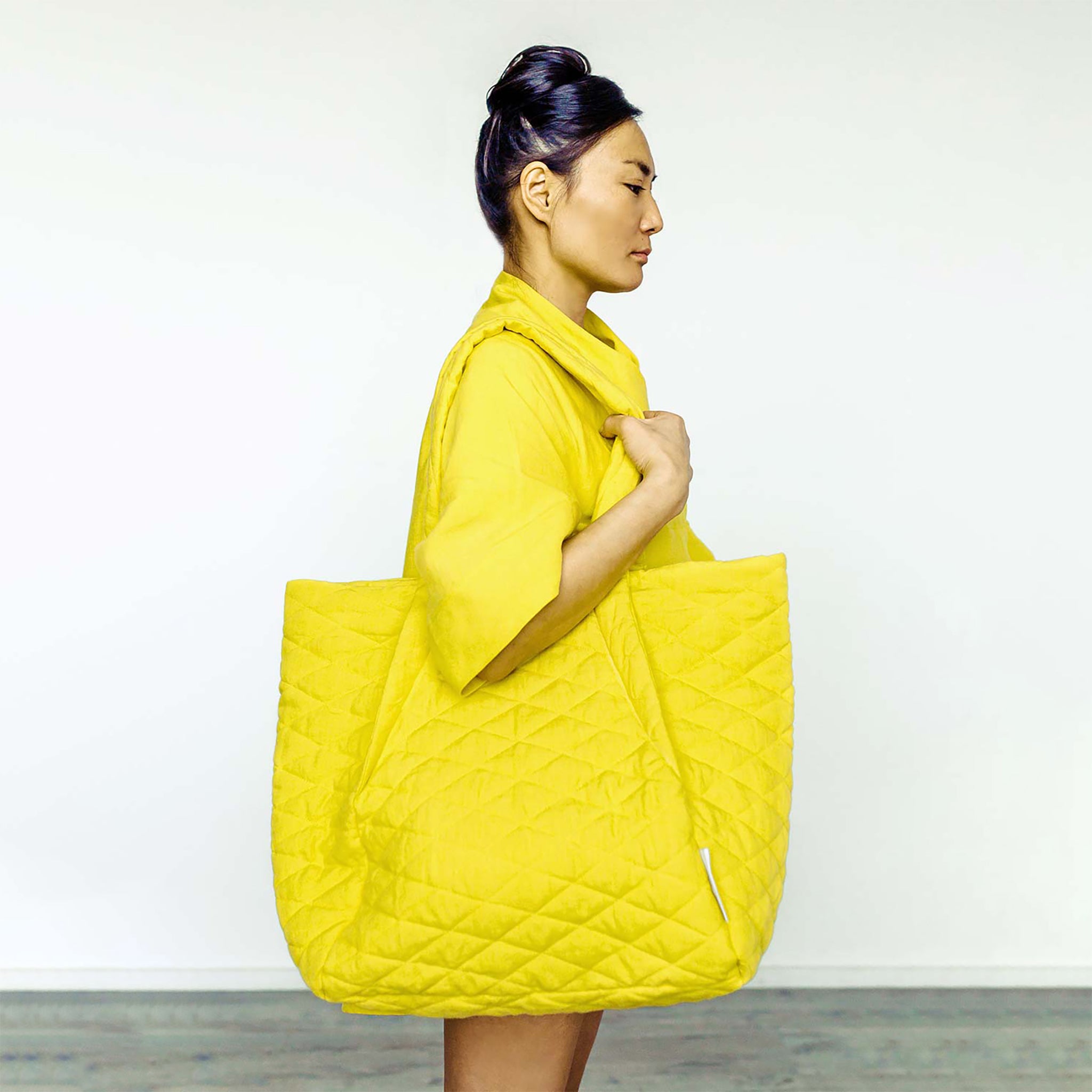 Woman wearing The Costume Room yellow Linen Cocoon Dress and yellow Linen Quilted Bag on shoulder