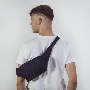 Man wearing The Costume Room Navy Blue Linen Quilted Belt Bag