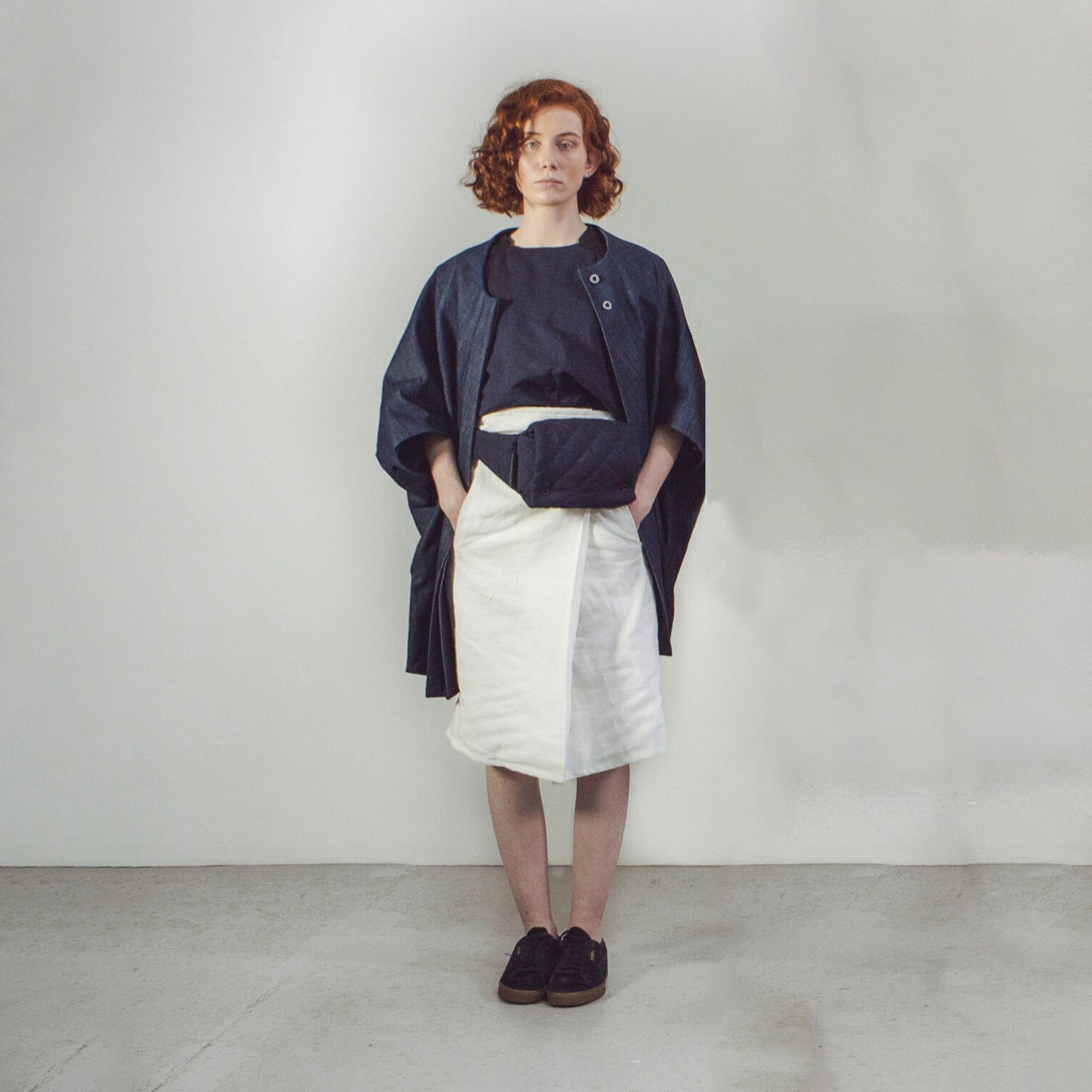 Woman with red hair wearing The Costume Room Navy Blue Linen Quilted Belt Bag