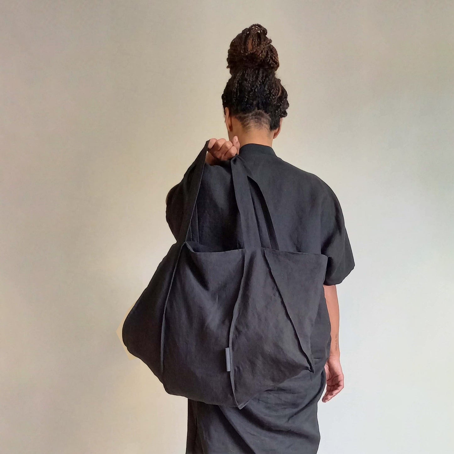 Man wearing The Costume Room Black Linen Tote Bag on his shoulder