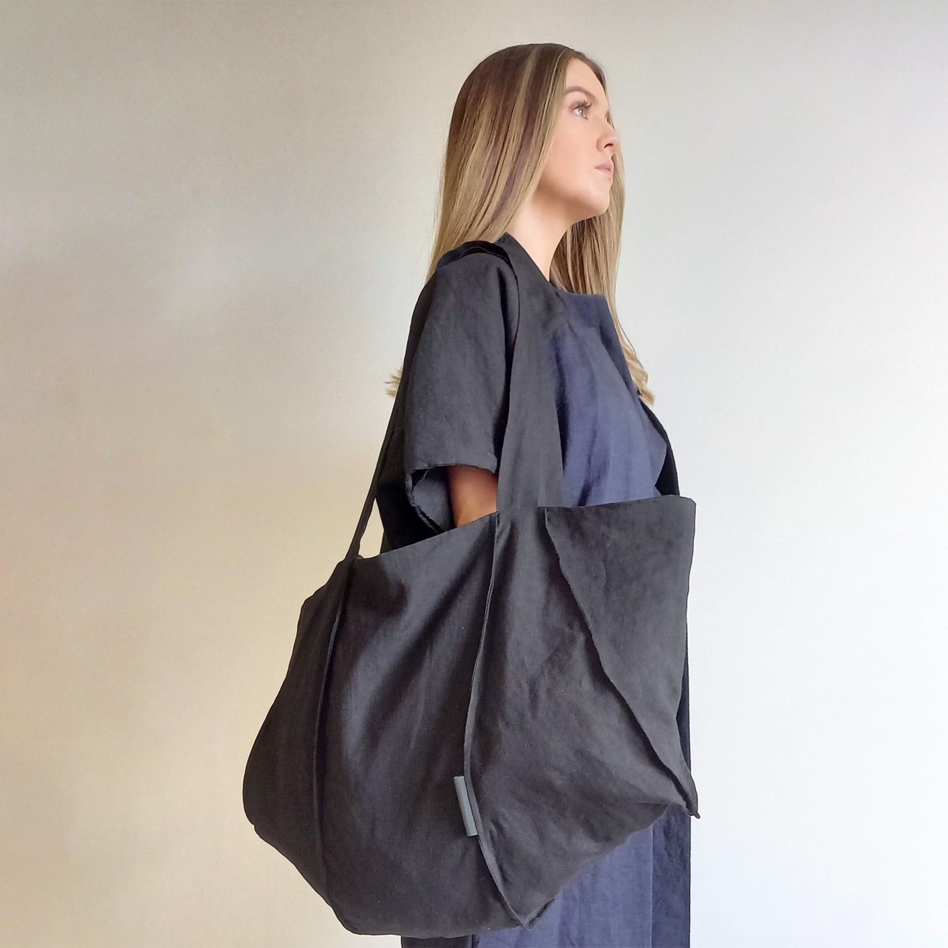 Woman wearing The Costume Room Black Linen Tote Bag on her shoulder