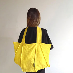 Woman wearing The Costume Room sunshine yellow Linen Tote Bag on her back