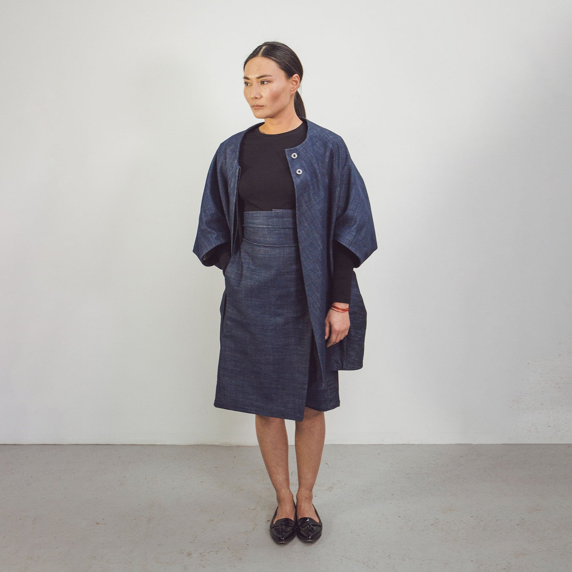 Woman wearing The Costume Room Raw Organic Denim Asymmetric Skirt