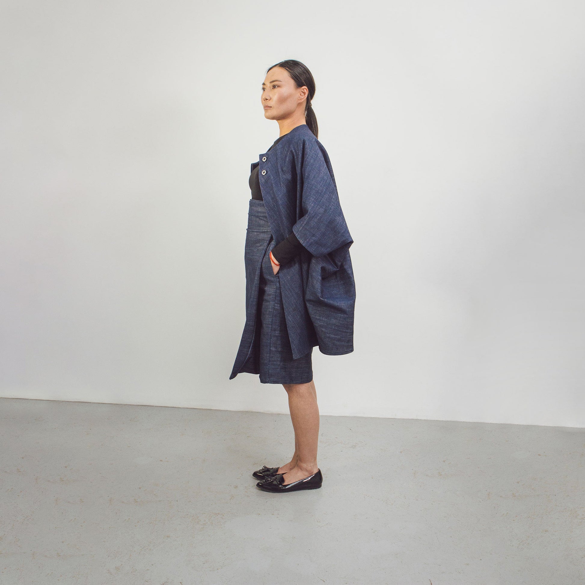 Woman wearing The Costume Room Raw Organic Denim Asymmetric Skirt