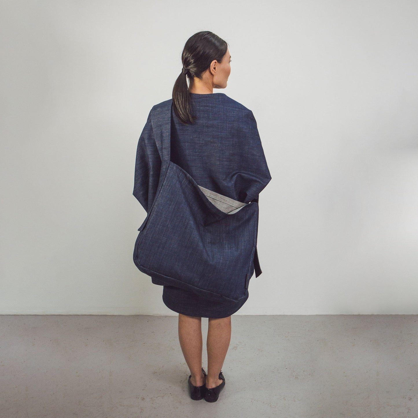 Woman wearing The Costume Room Raw Organic Denim Crossbody bag