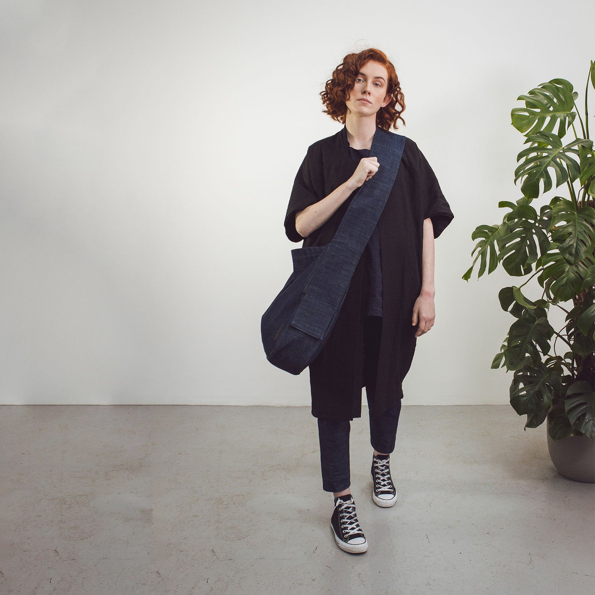 Woman wearing The Costume Room Raw Organic Denim Crossbody bag