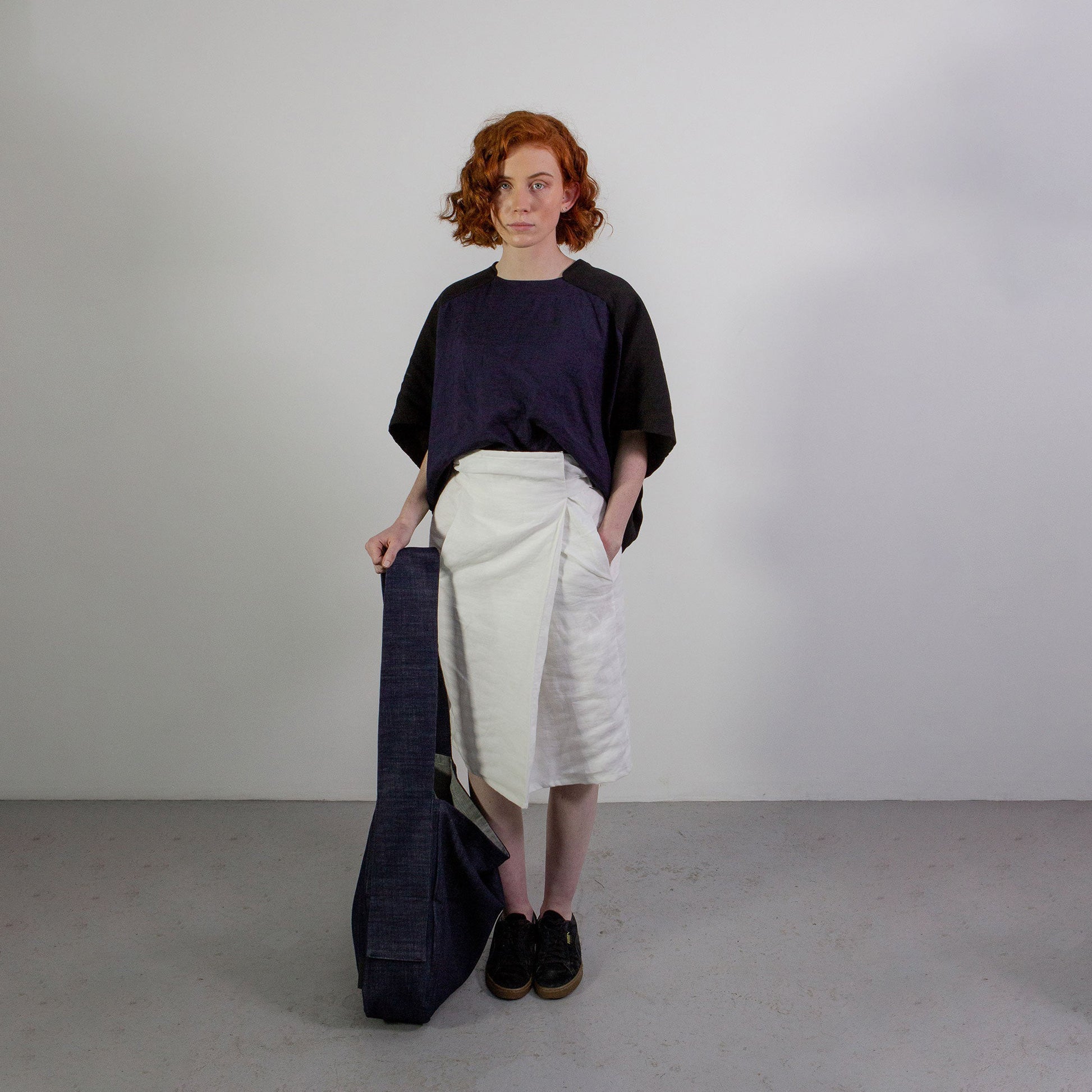Woman with red hair wearing The Costume Room Raw Organic Denim Crossbody bag