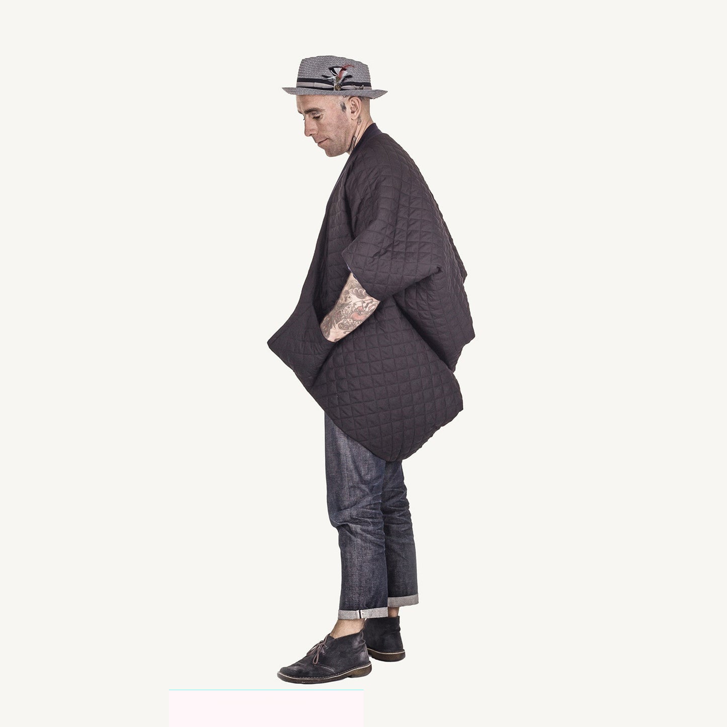 Man wearing The Costume Room The Gar coat kimono style black linen quilted coat with navy collar