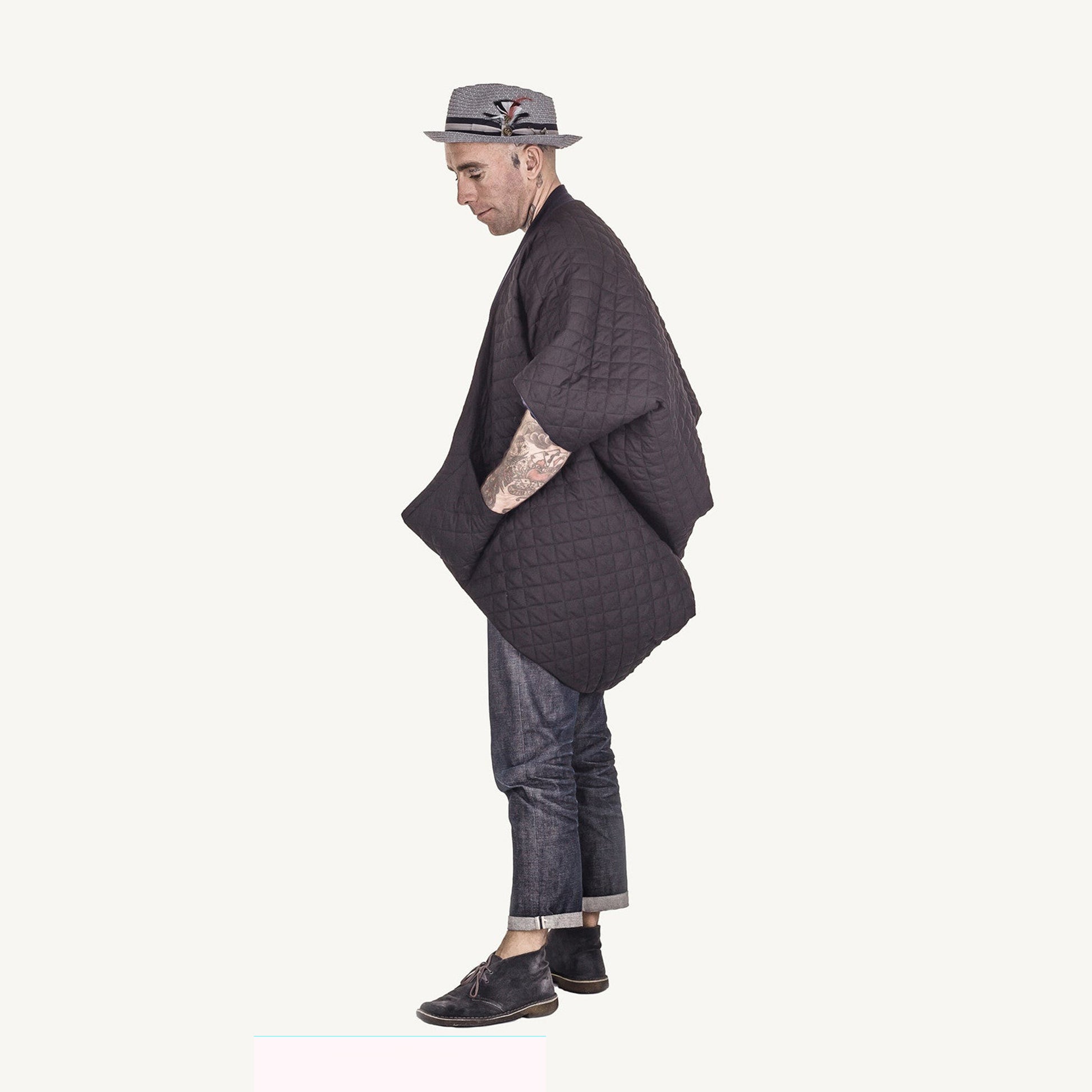 Man wearing The Costume Room The Gar coat kimono style black linen quilted coat with navy collar